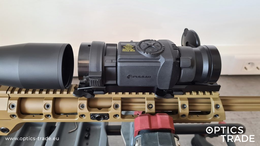 Pulsar Core FXQ50 mounted on a Picatinny rail in front of a riflescope with a suitable adapter